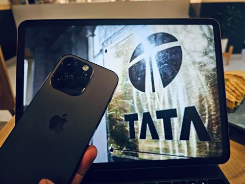iPhone 14 Pro in front of TATA logo on iPad