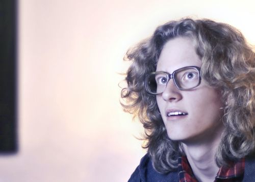 Woman wearing glasses staring at a screen