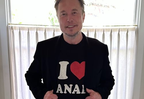 Elon Musk smiling at the camera.